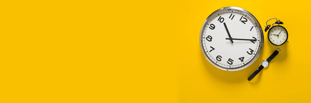 pocket watch and wristwatch on yellow background